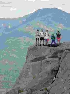 low-res photo of hiking group on rock